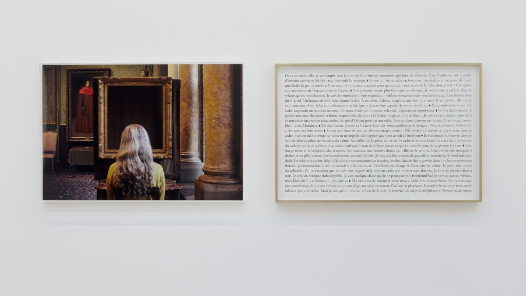 Art photograph of a woman seen from behind with long, light hair standing between columns. A text is displayed beside it.