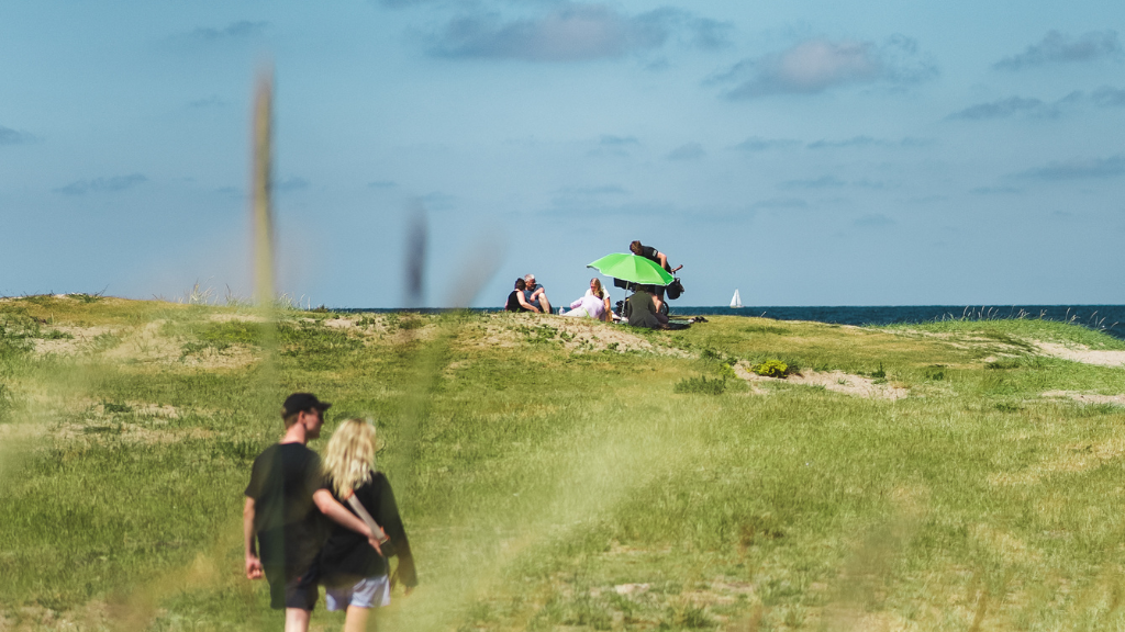 A couple walks on the beach in Gilleleje