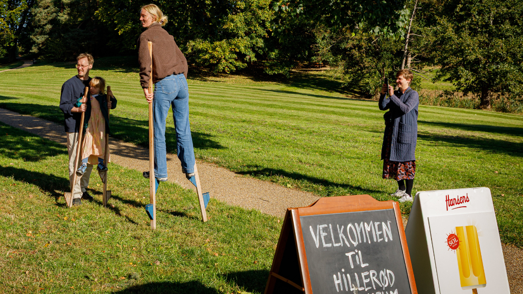 Woman on stilts in front of Hillerød Museum