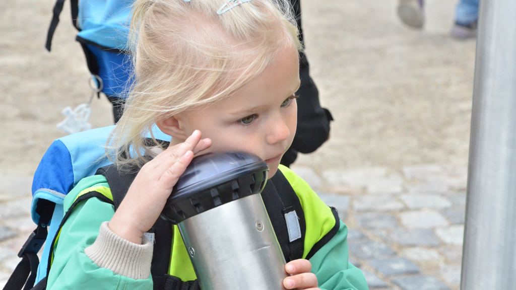 Girl listening in a tube at sound playground in Esbjerg