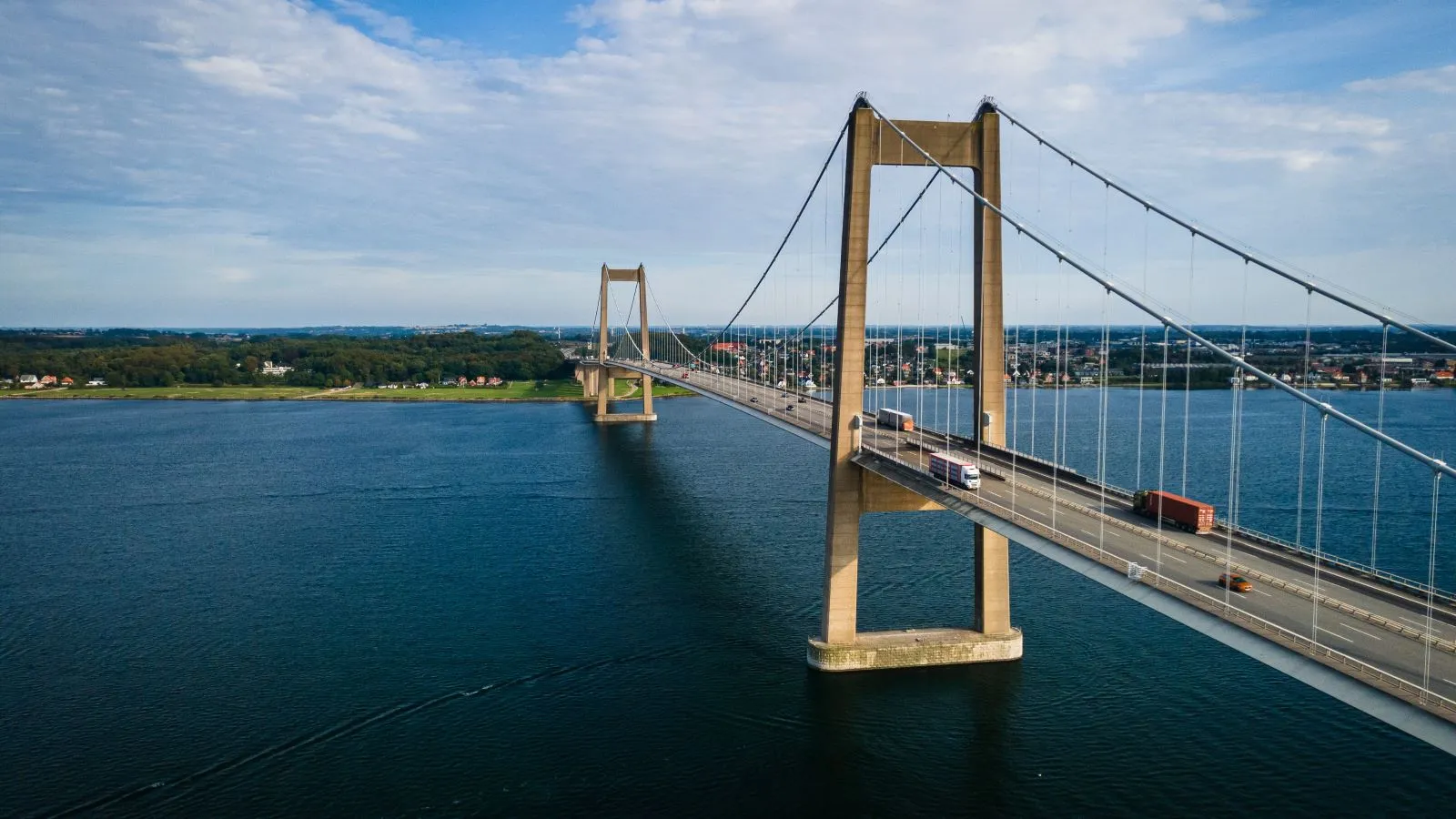 The New Little Belt Bridge. Cars and trucks are driving on the bridge.