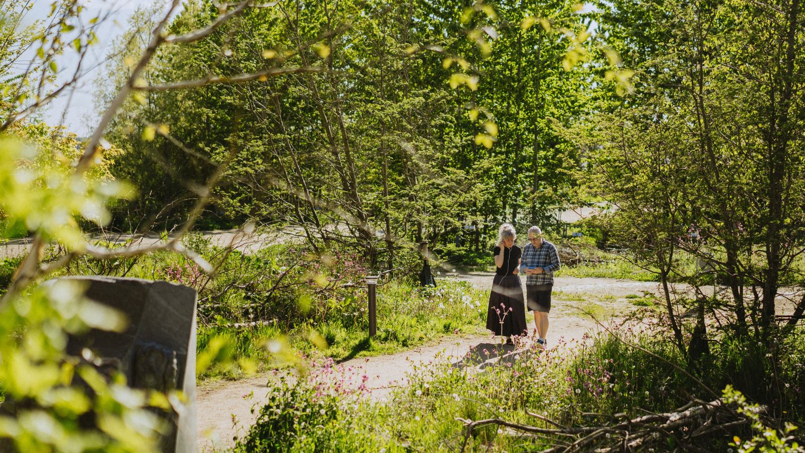 A couple walks on an art walk through Søndervold Nature Park.