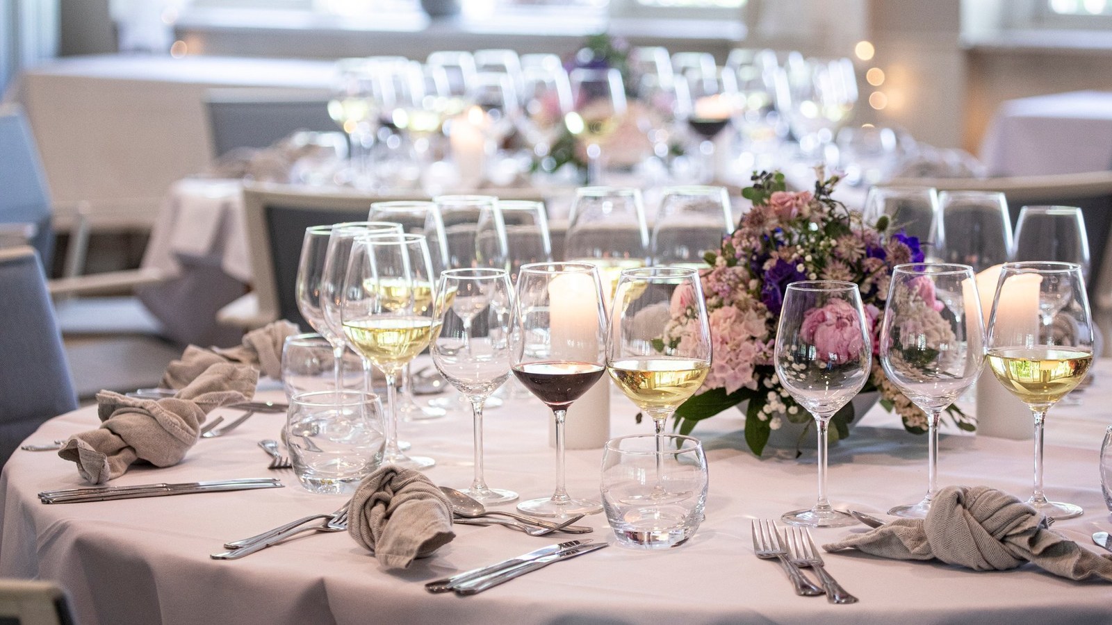 Festtafel mit Weingläsern, Kerzen und Blumen im Hotel Strandparken