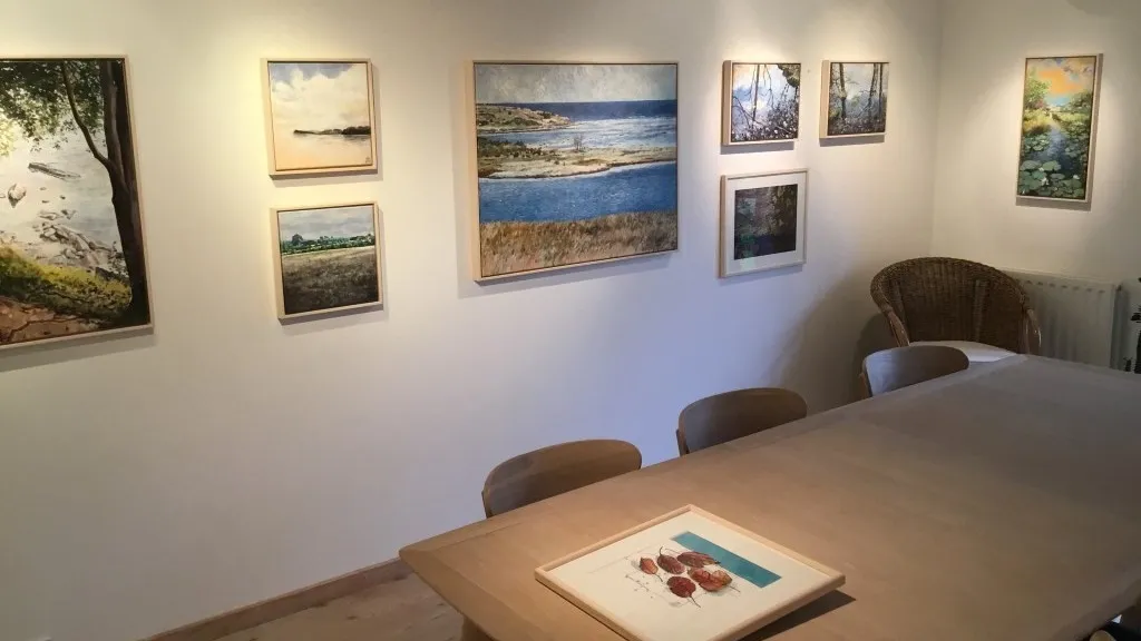 Photograph by Galleri Brogaard showing a section of the art exhibition in the form of paintings.