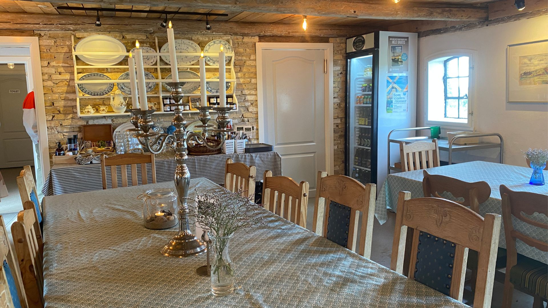 Indoor dining areas at Fynshoved Cafe and Gårdbutik in an old-fashioned and cozy style.