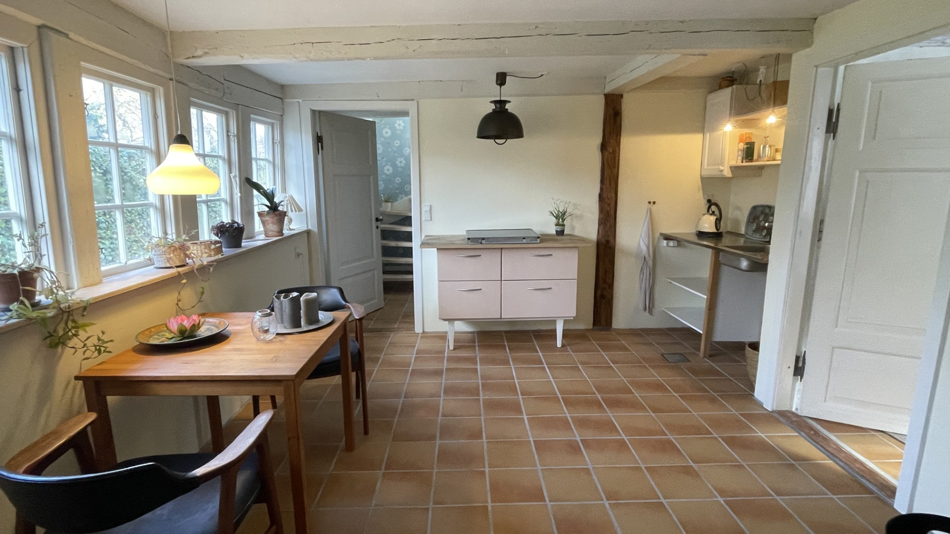 Living room with kitchenette and wood-burning stove