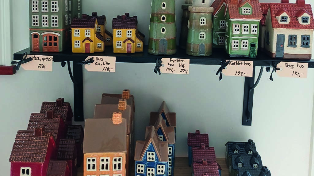 Ceramic houses on shelves.
