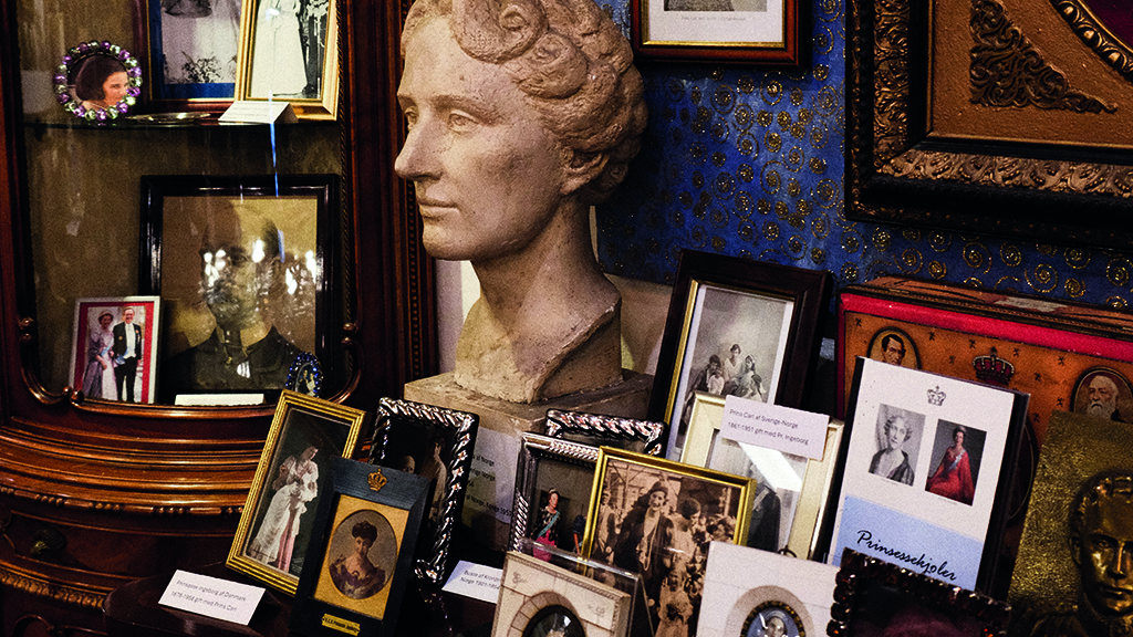exhibition featuring many small pictures of royals and a bust