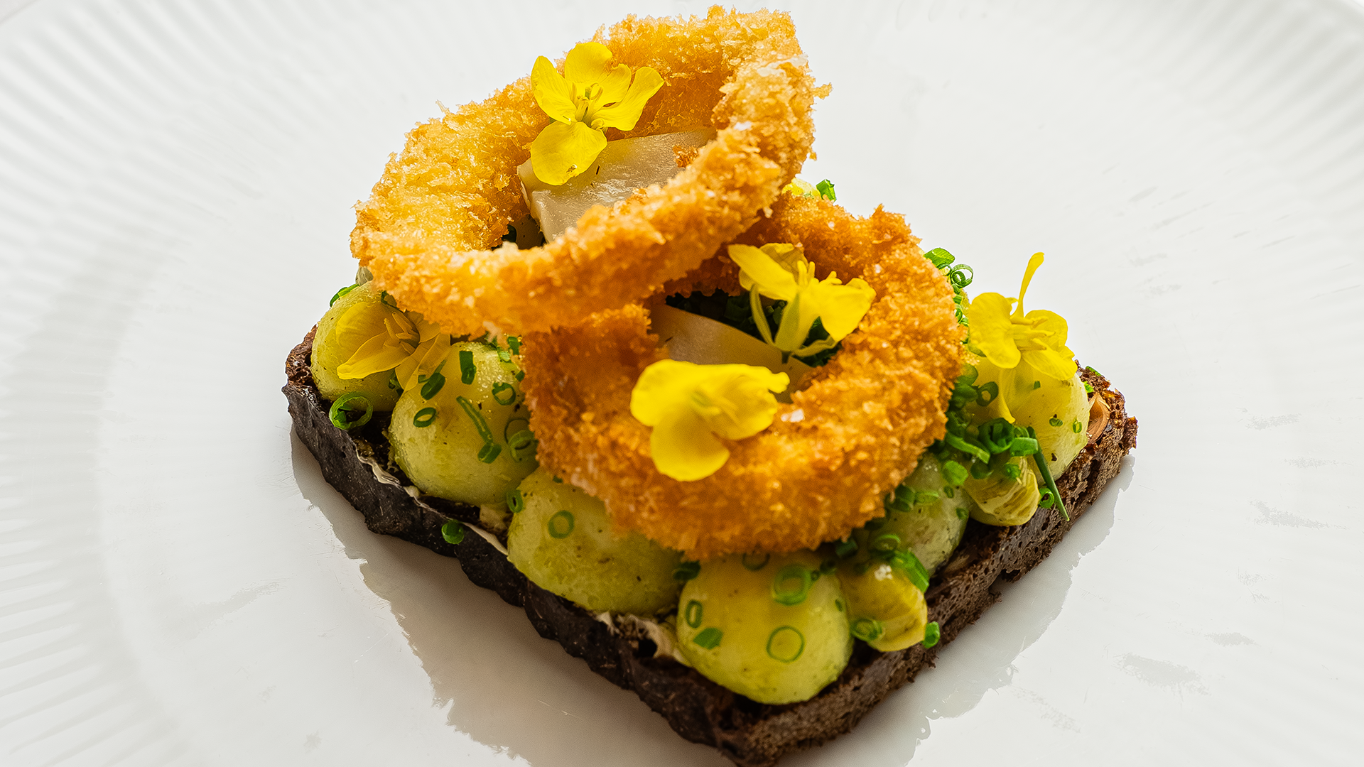 Open-faced potato sandwich with garnish