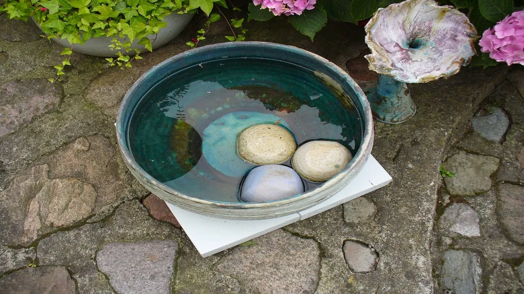 Ceramic dish with stones and water in it