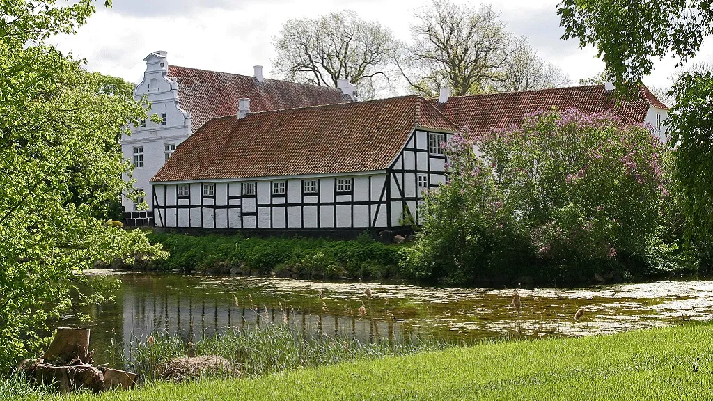 The half-timbered building of Kørup Castle seen from the moat