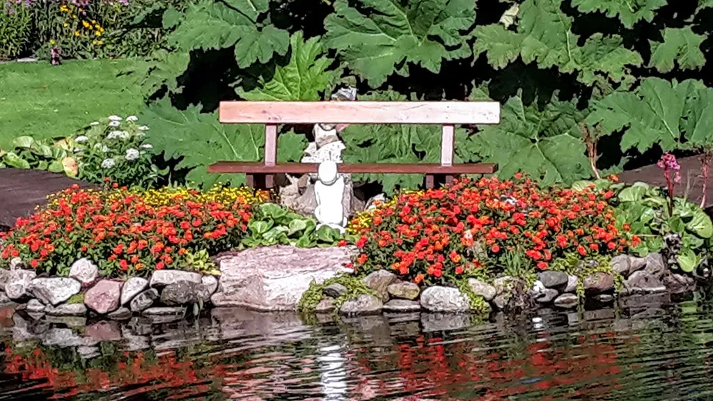 Bench by the lake in Kongsdal Open Garden