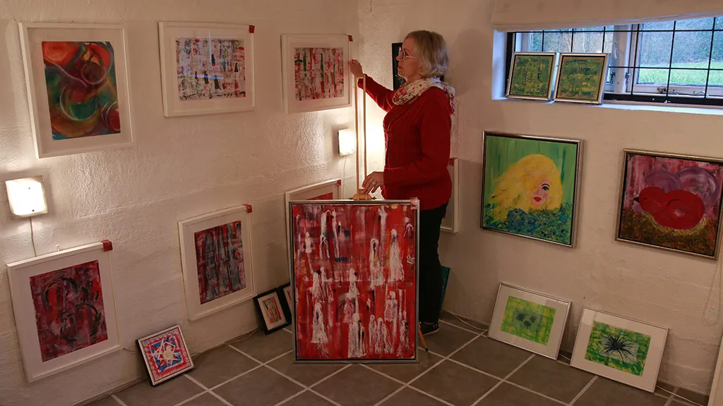 Artist Sonja Foged with her artworks