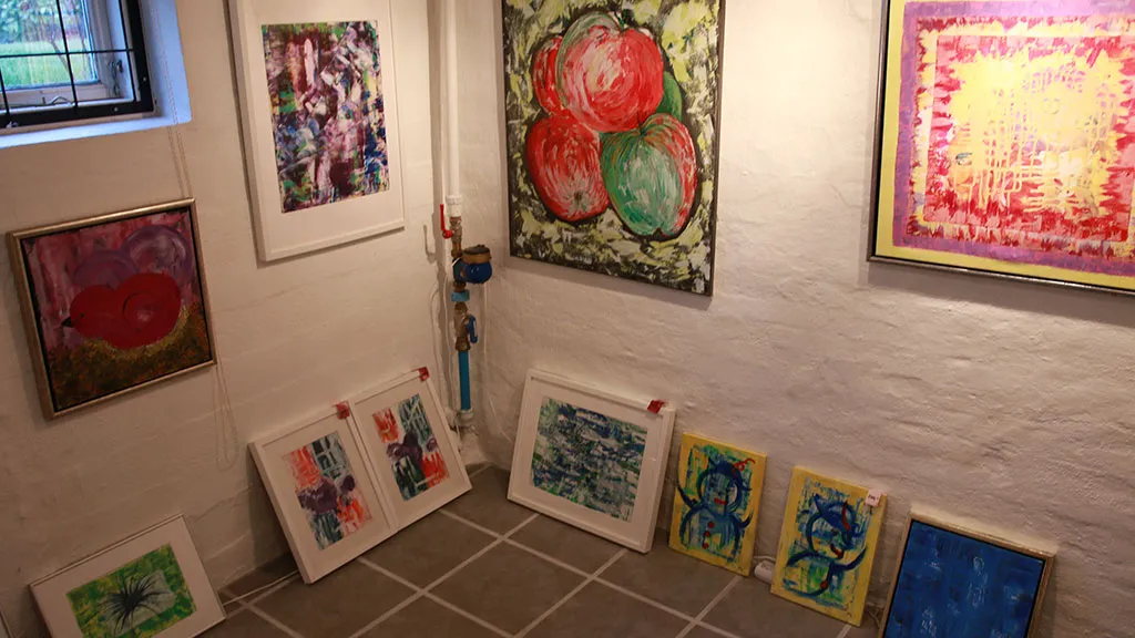 A wall with works of art in Foged's Gallery