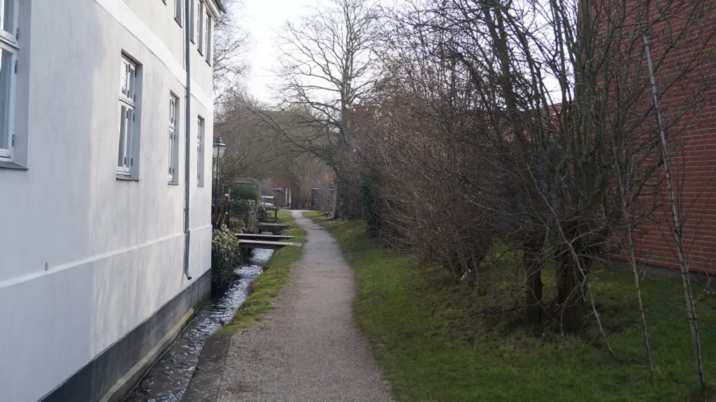 Tall buildings on either side of the watchman's path in Bogense