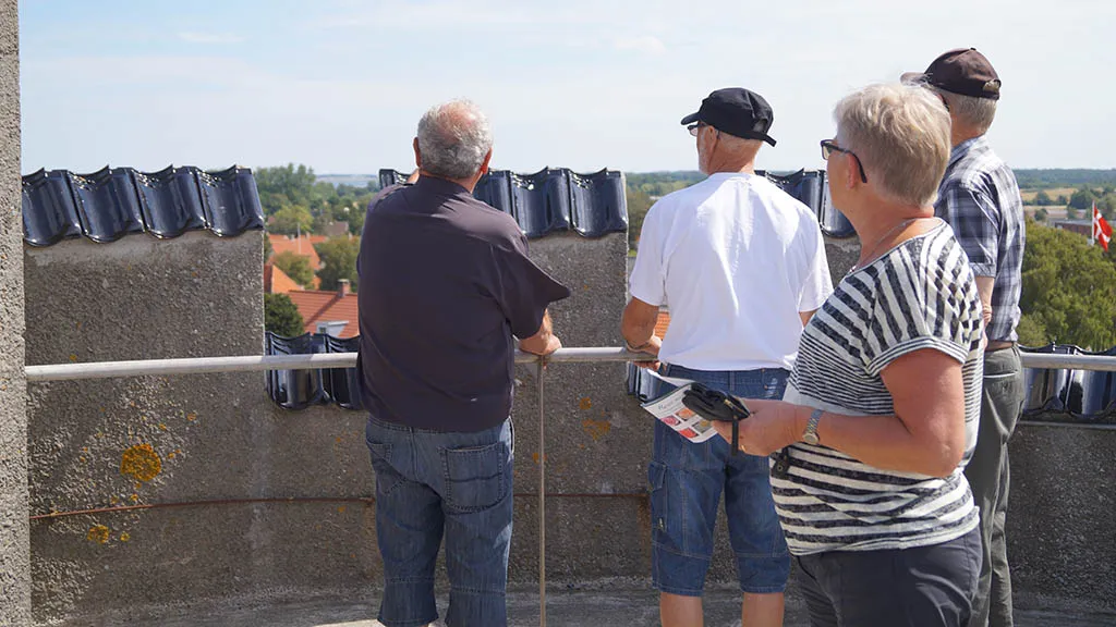 People look out from the Bogense Water Tower