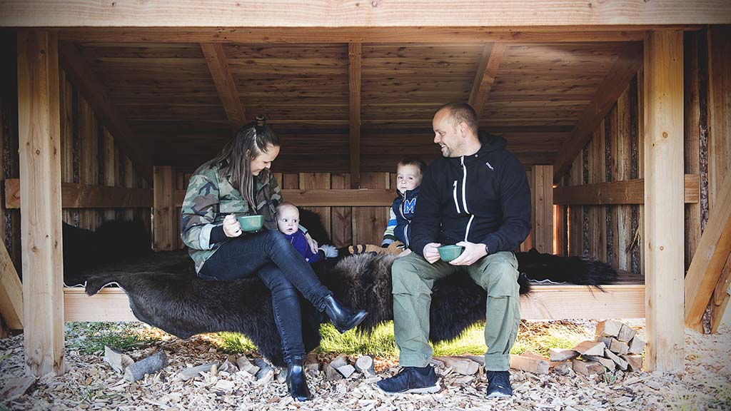 Family sits in shelter at Ditlevsdal Bisonfarm