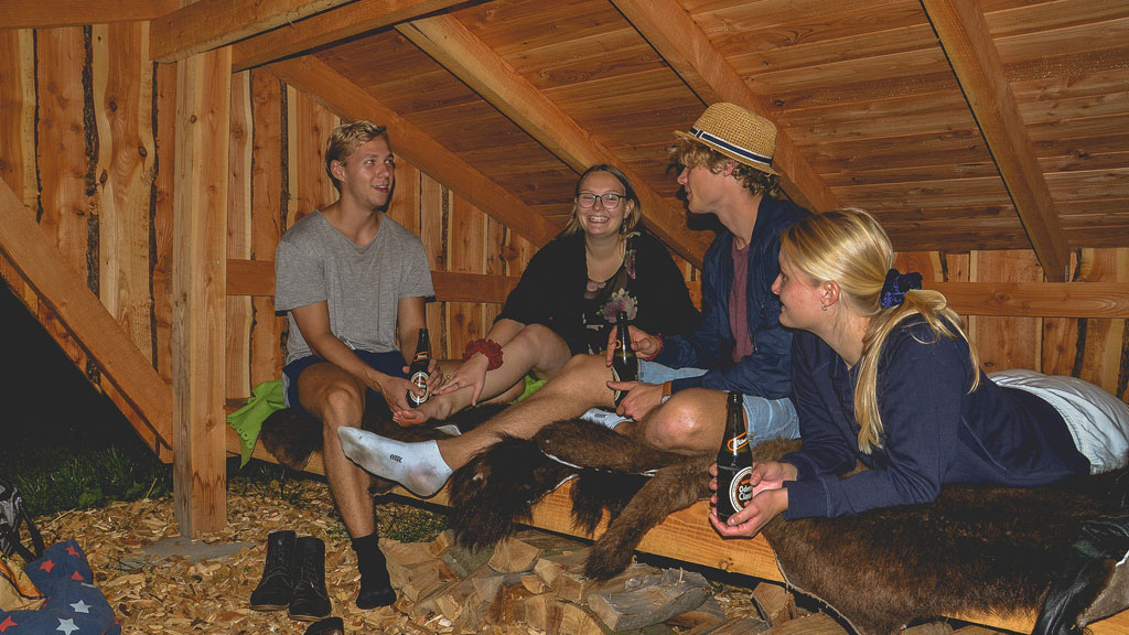 Young people having fun and enjoying a beer in the shelter at Ditlevsdal