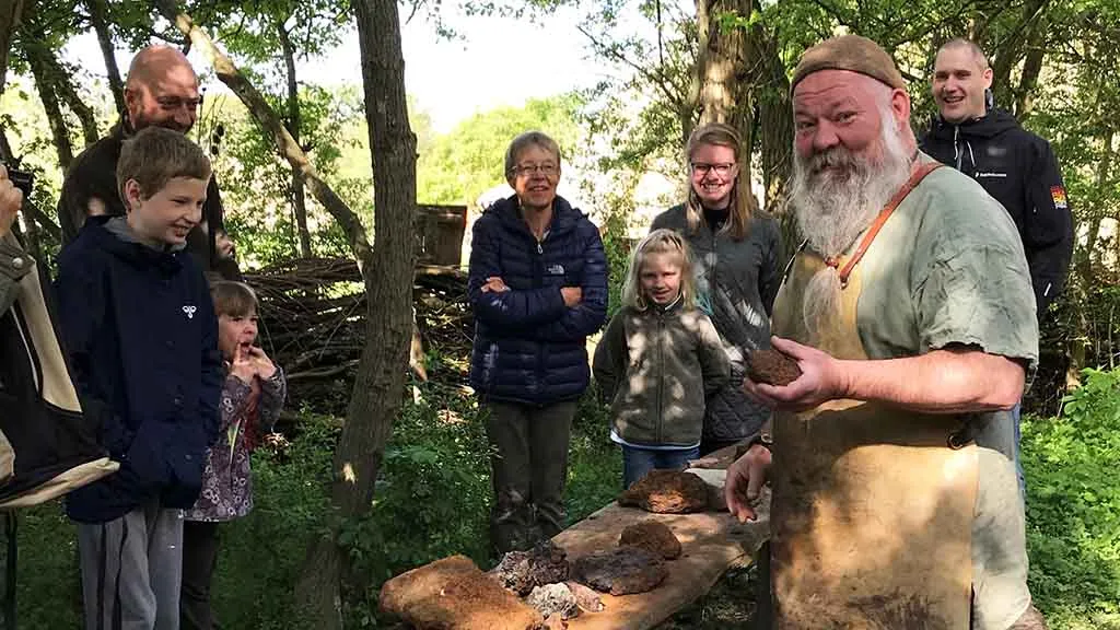 Family on a tour of the Iron Age village