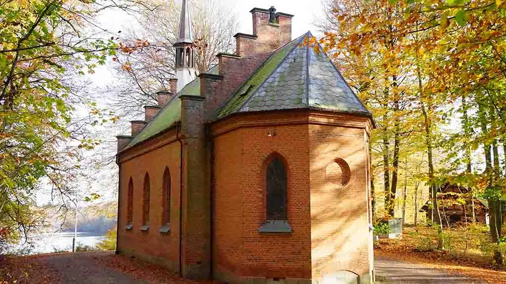Langesø Forest Chapel with the tower and the lake in the background