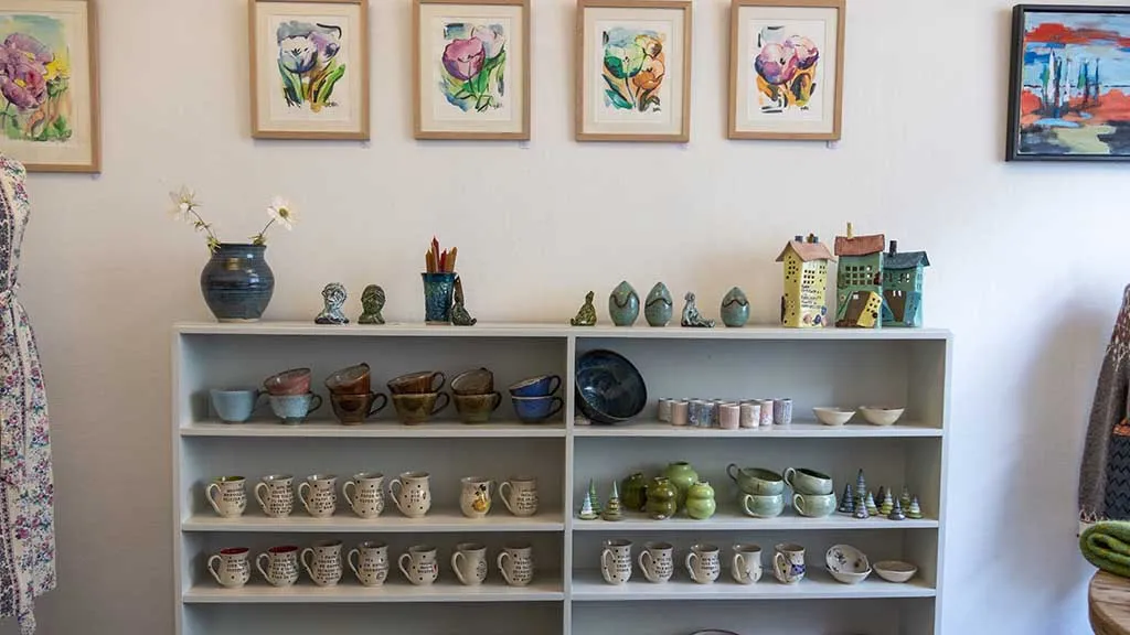 Paintings and sculptures on the shelf in Gallery East