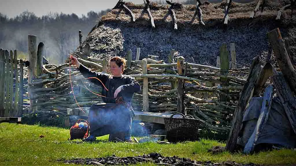 Woman spinning yarn in the Iron Age village