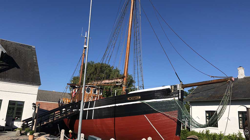 Castor in dry dock with the old white house in the background