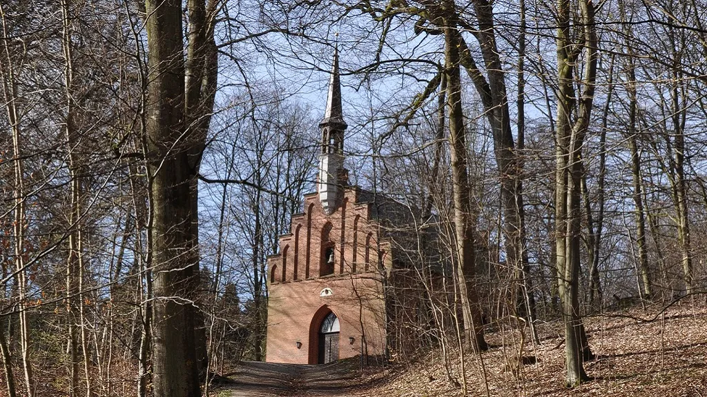 Langesø Forest Chapel seen from inside the forest path in winter