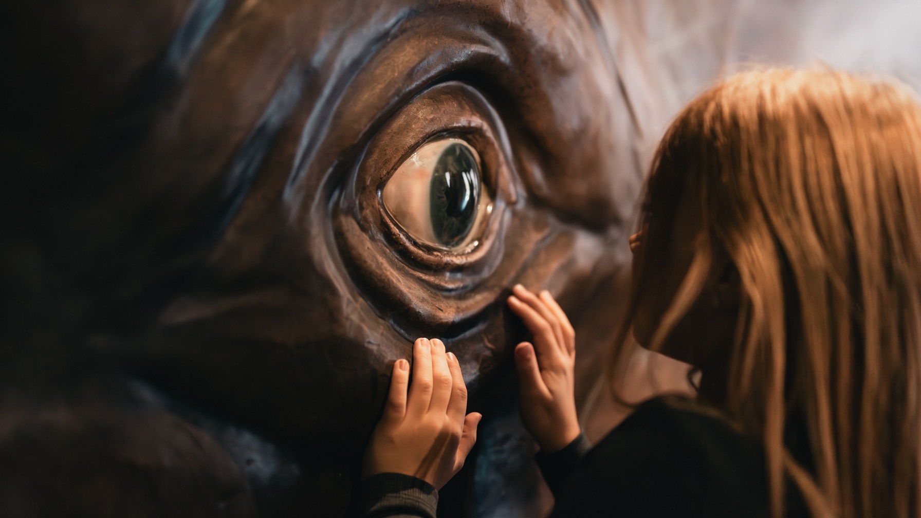 Child by a large eye