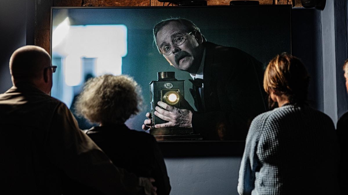 Visitors watch a film