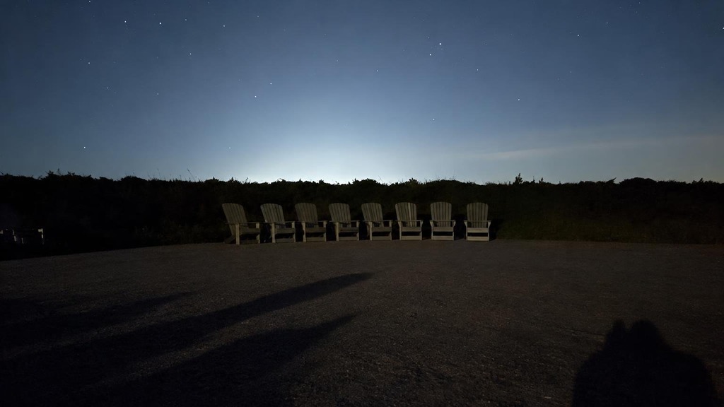Chairs under a night sky