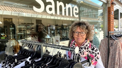 The owner of Boutique Sanne in front of her store