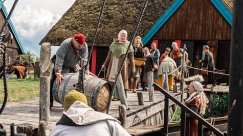 Vikings at the harbor with a barrel