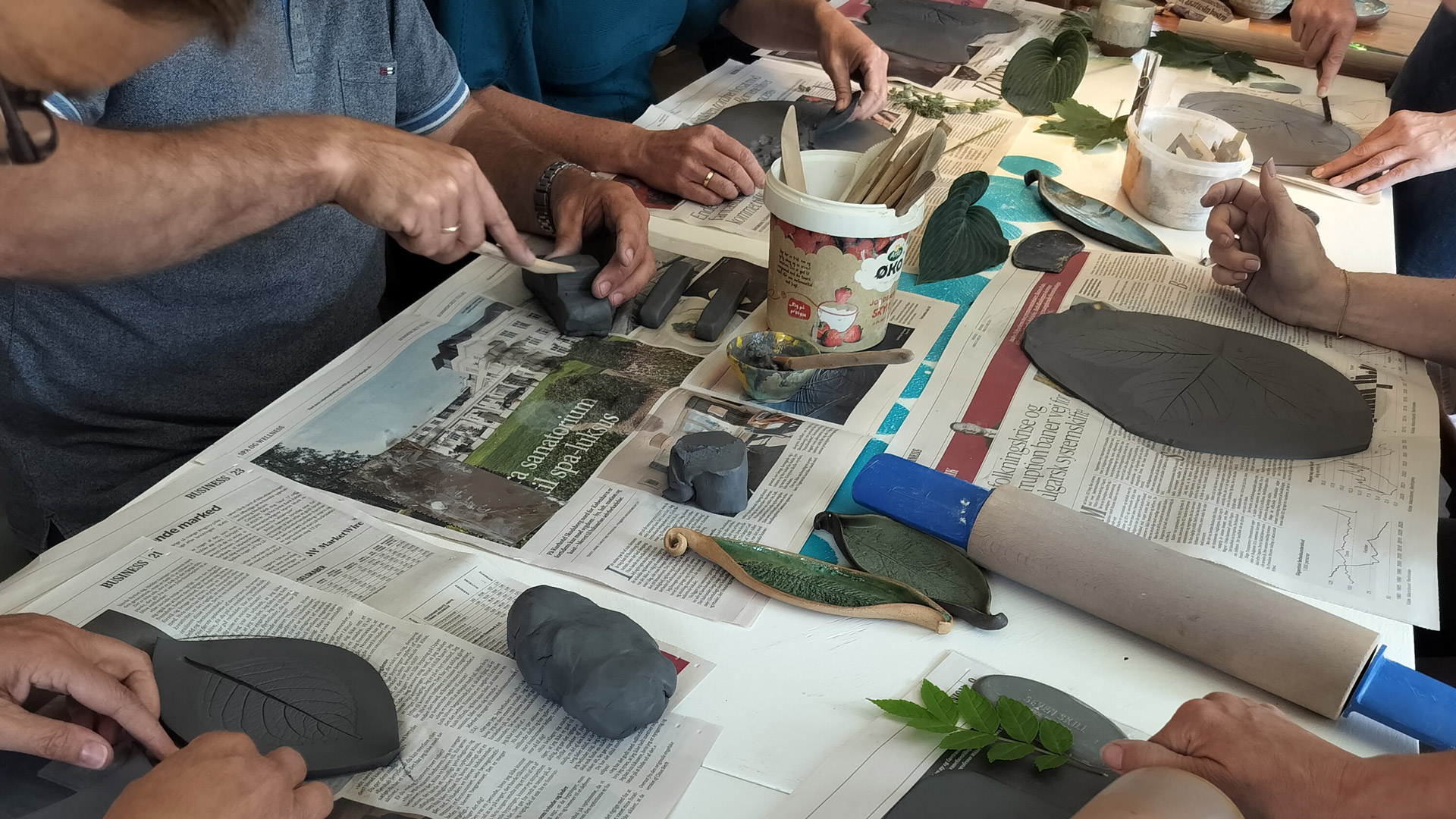 Ceramics workshop creating leaf impressions in clay