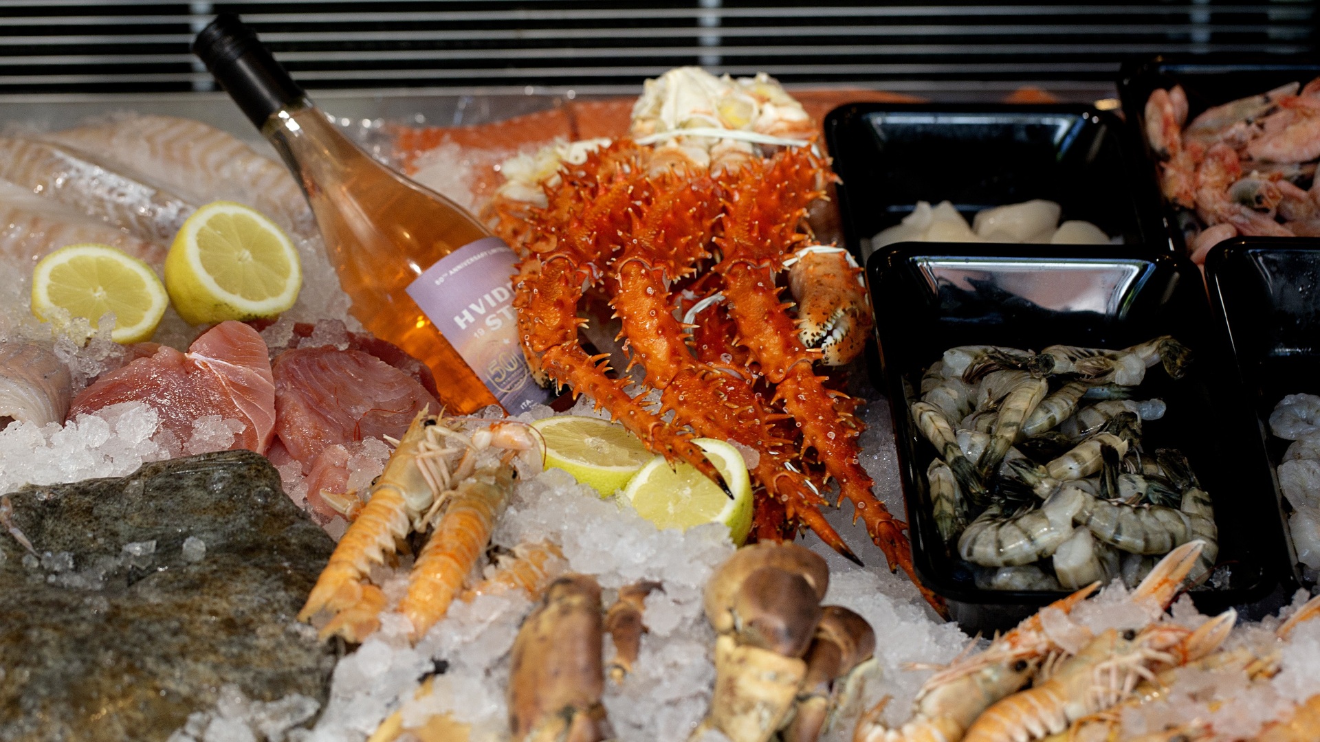 Fresh fish and seafood displayed on ice at a fish counter.