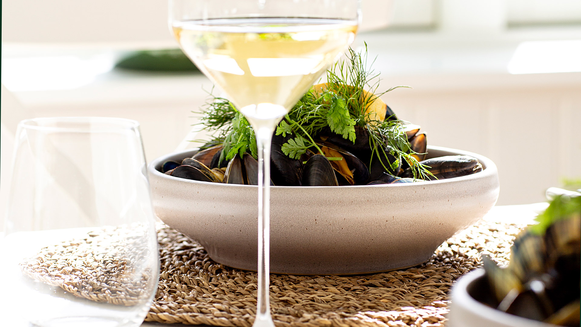 Mussels with fresh herbs and a glass of white wine.