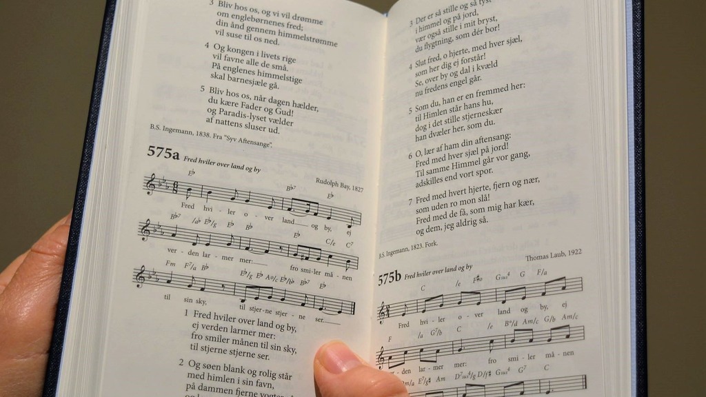 The picture shows a hymn book lying open.