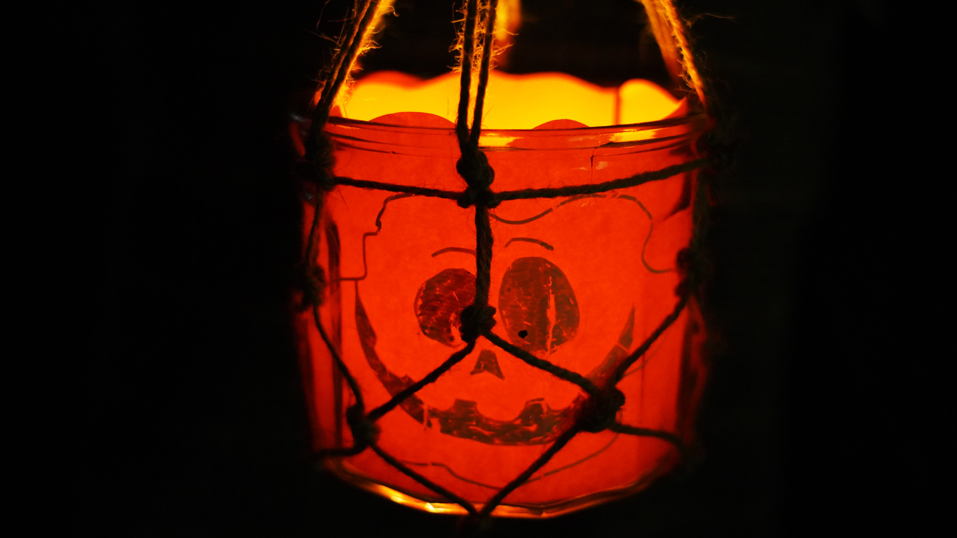 Homemade Halloween lantern with a glowing skull design.