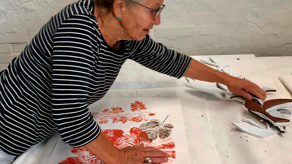 Britt Smelvær at her graphic printing press