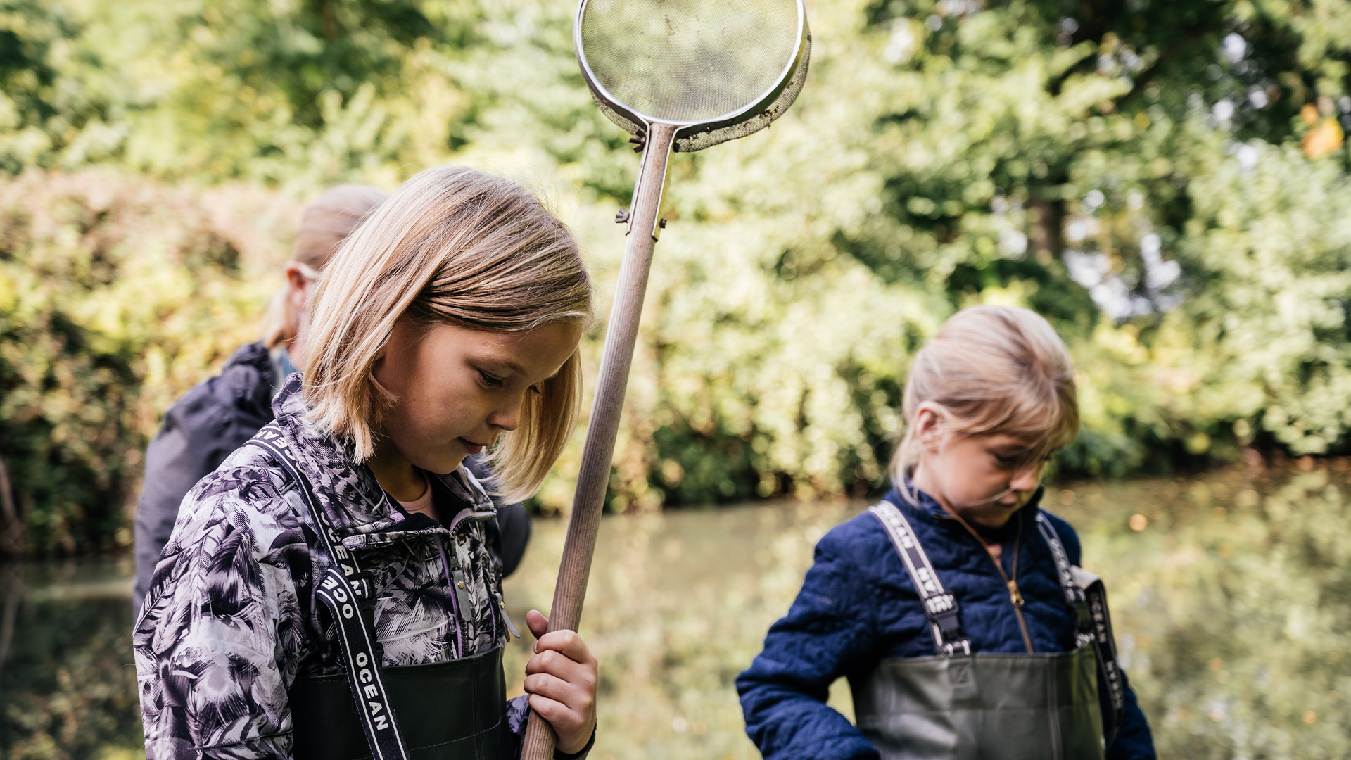 Children exploring the waterhole at Skovsgaard Nature Destination