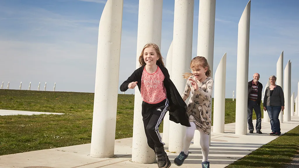Children running around the monument square at Kongernes Jelling