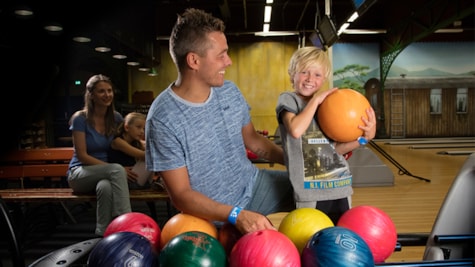 Father and son having fun while bowling