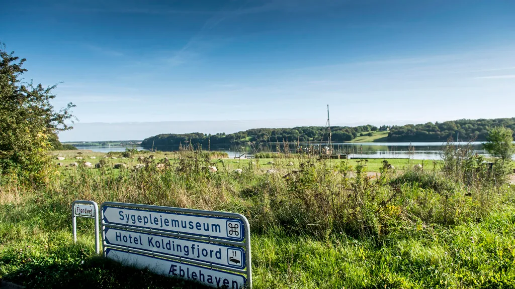 City sign by the fjord