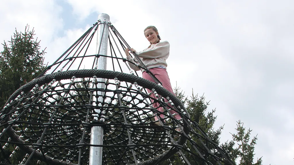 A girl climbs to the top of the play tower at one of Skærup Zoo's playgrounds
