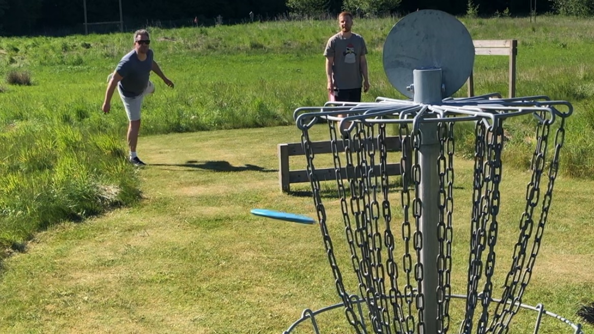 Friends vie at disc golf