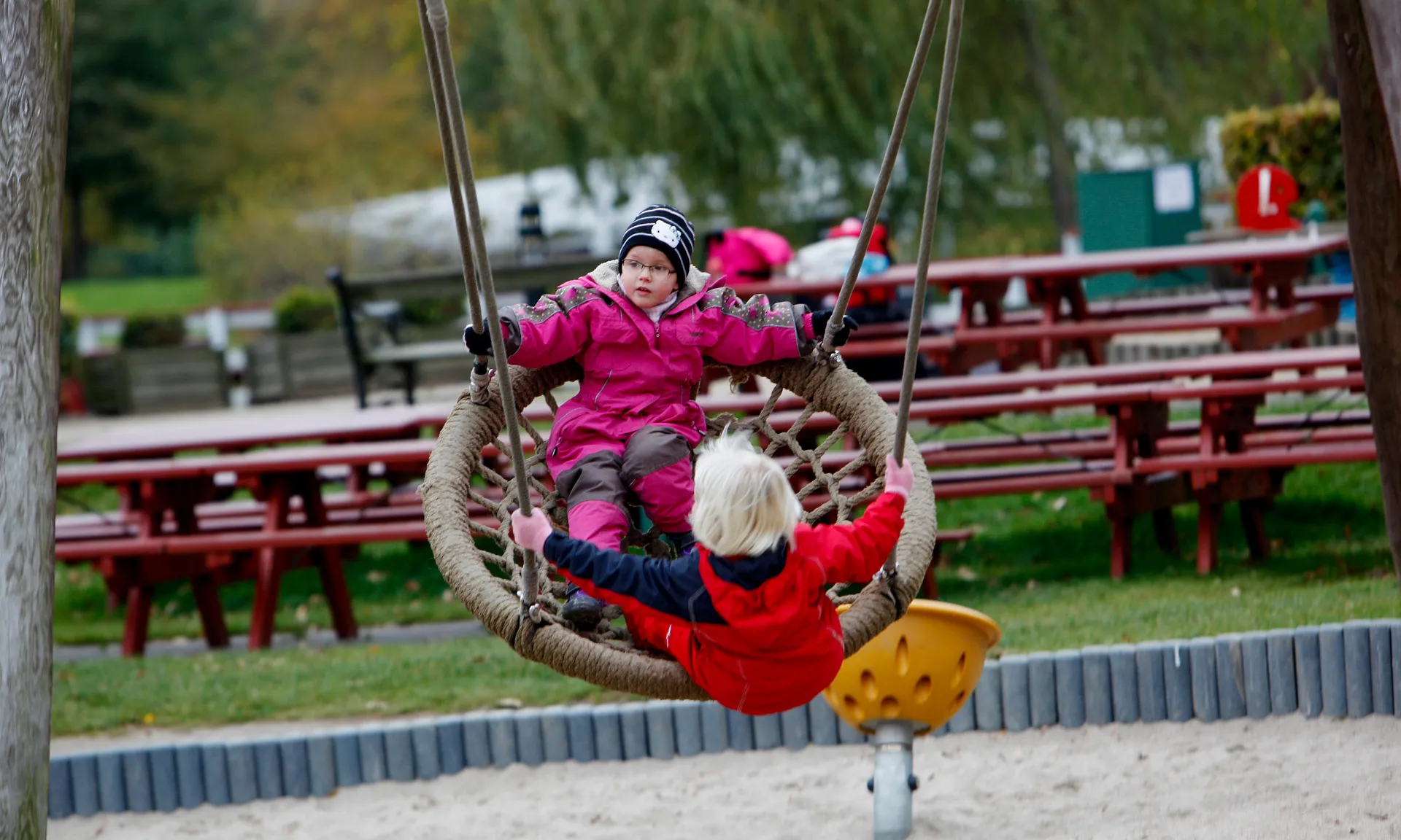 Children playing on a swing in the playground