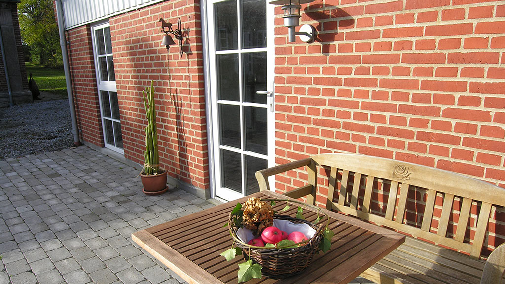 Table and bench in front of Rude Hougaard B&B in Odder
