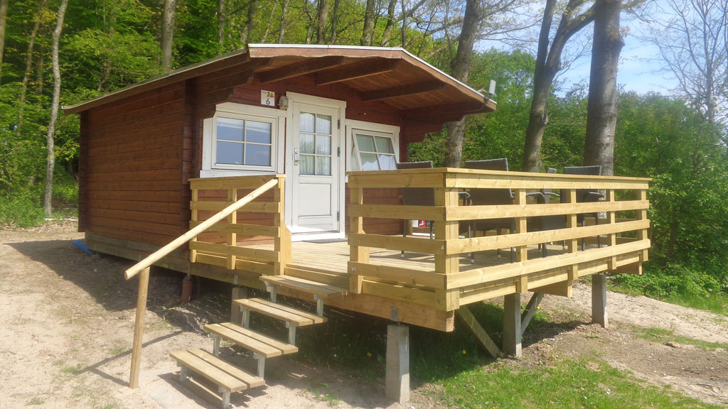 A camping cabin with a large wooden terrace at Horsens City Camping