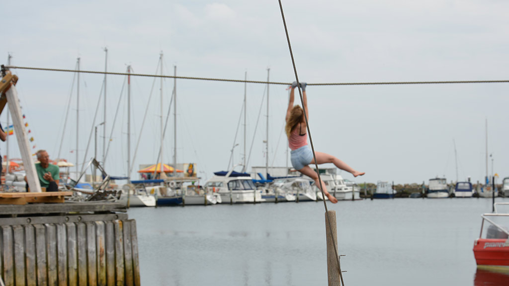 En pige på zipline over havnebassinet i Hou