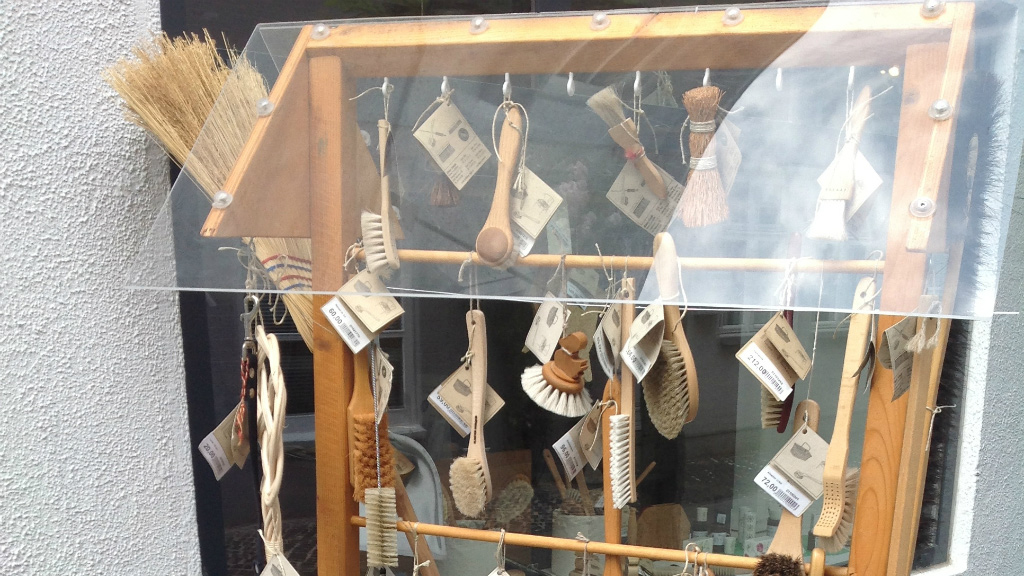 Brushes hanging on hooks at Blindes Arbejde in Horsens